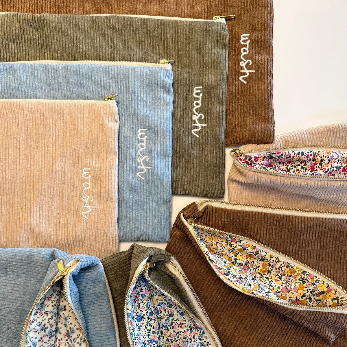 Collection of fabric pouches in various colors with floral patterns and 'woven' branding.